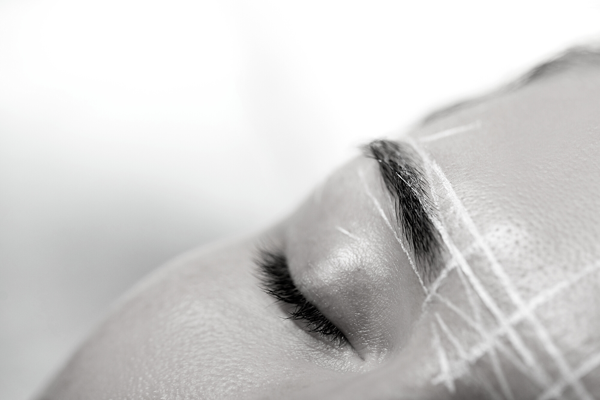 Female Brow during Professional Eyebrow Mapping Procedure